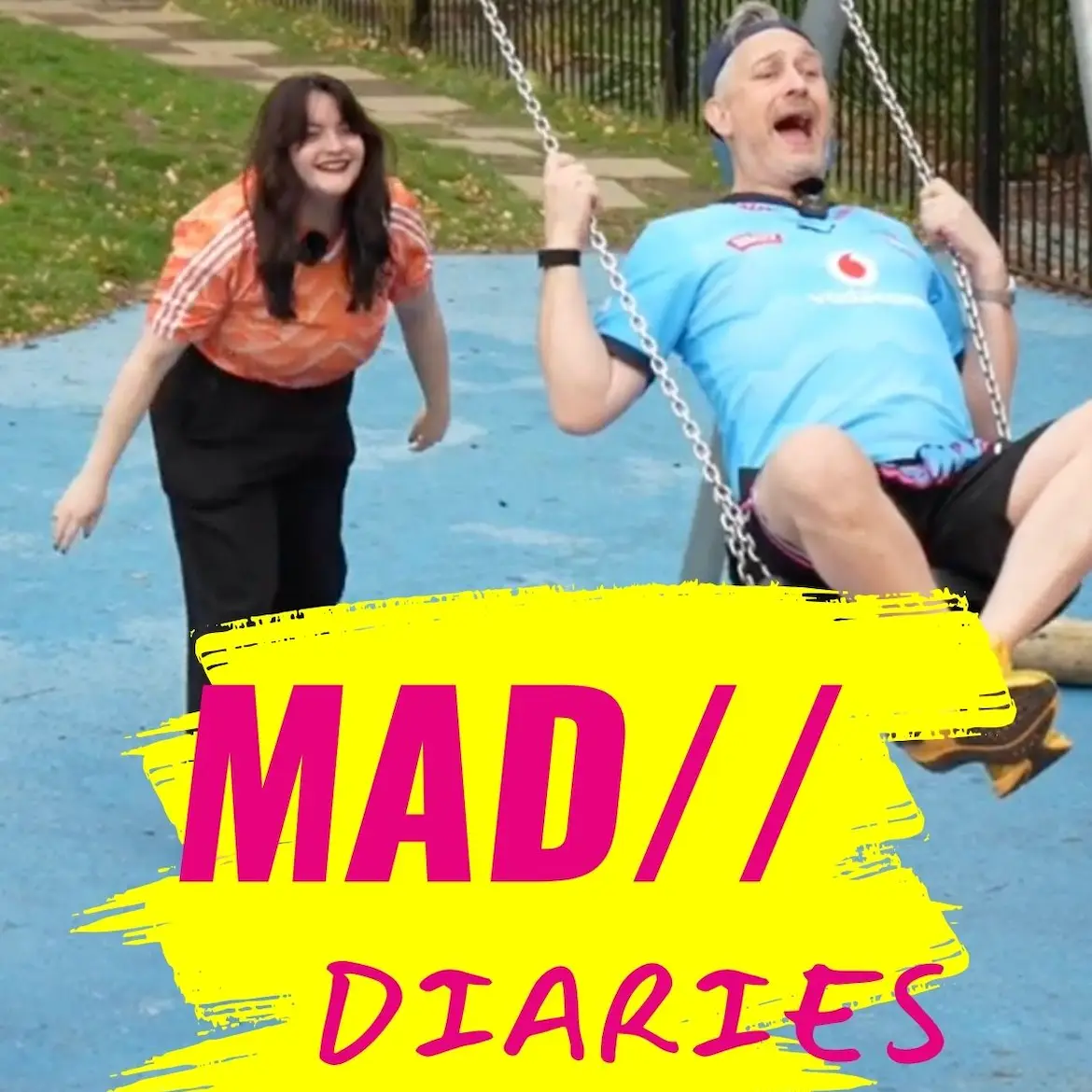 A man laughs on a playground swing near a smiling woman with MAD// DIARIES text